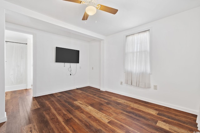 interior space with dark wood-type flooring and ceiling fan