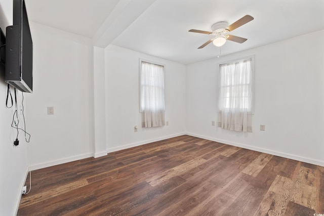 spare room with ceiling fan and dark hardwood / wood-style floors