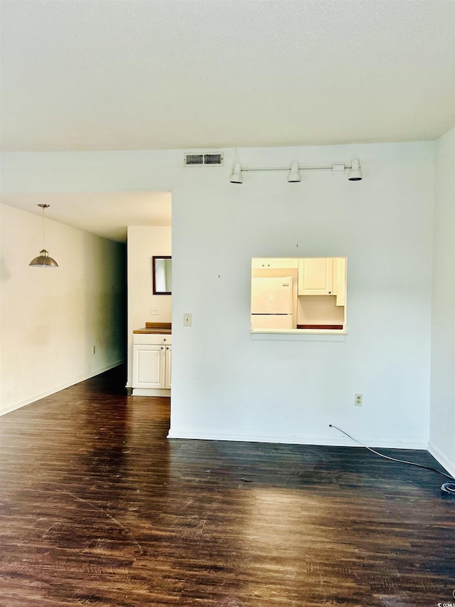 empty room featuring dark hardwood / wood-style flooring