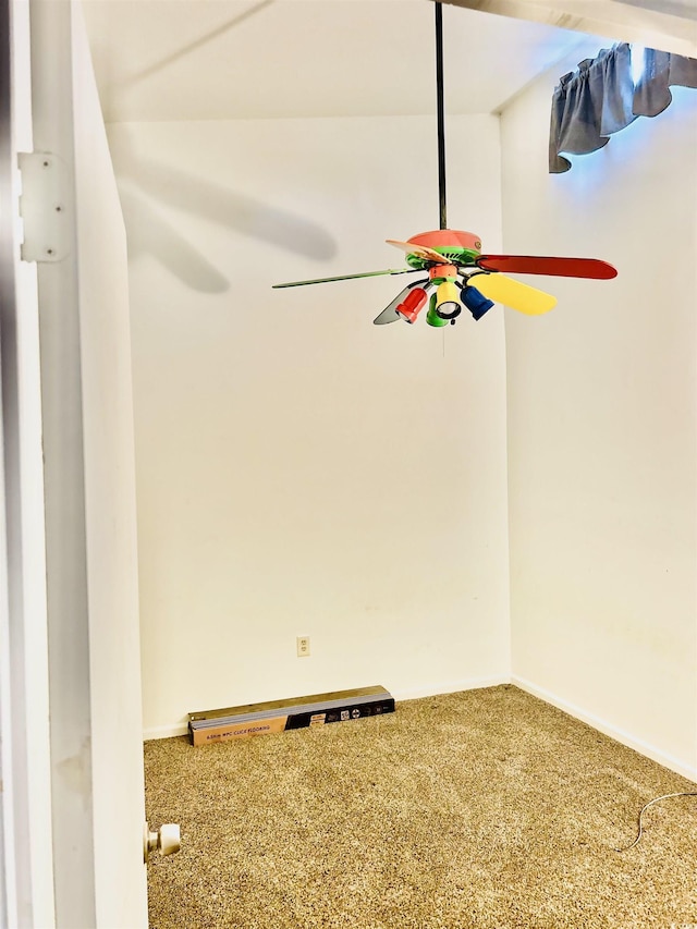 unfurnished room with ceiling fan and carpet