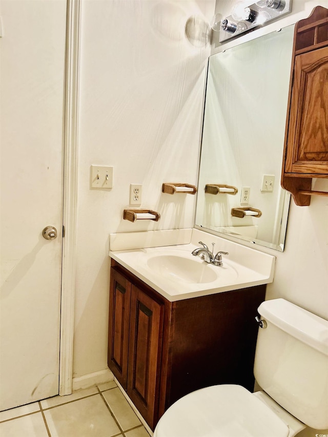 bathroom featuring vanity, tile patterned flooring, and toilet