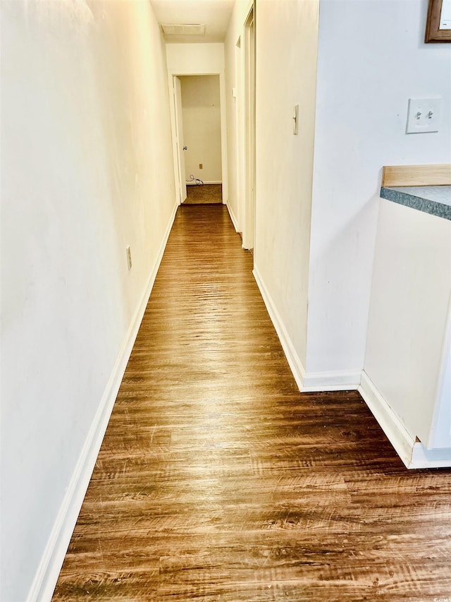 hall with hardwood / wood-style flooring