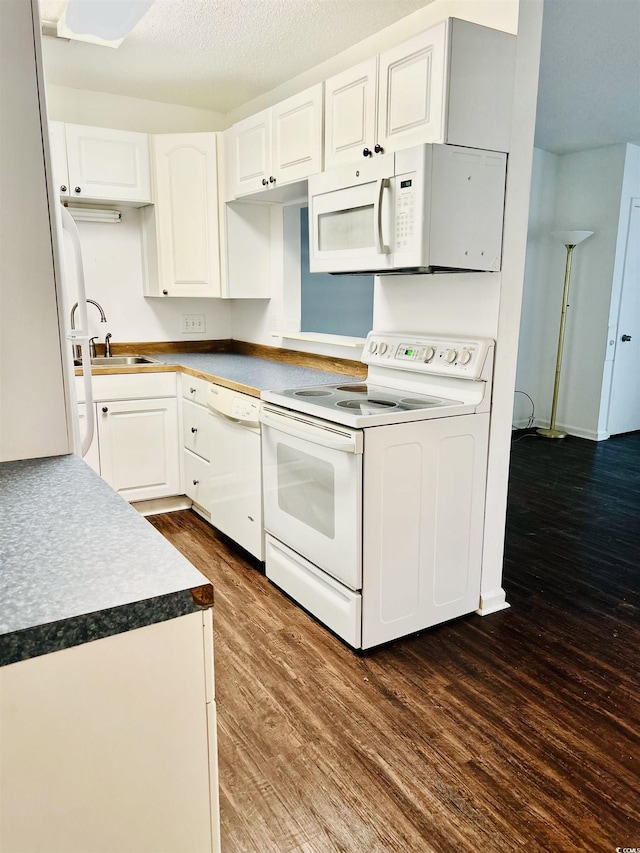 kitchen featuring dark hardwood / wood-style floors, sink, white cabinets, white appliances, and a textured ceiling