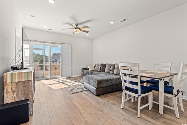 living room featuring ceiling fan and light wood-type flooring