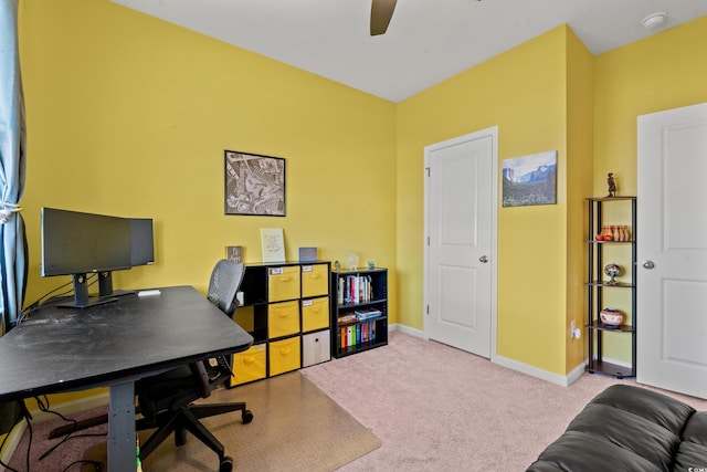 carpeted office featuring ceiling fan