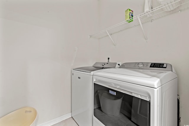 laundry area featuring light tile patterned flooring and washer and dryer