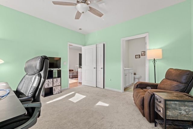 home office featuring light colored carpet and ceiling fan