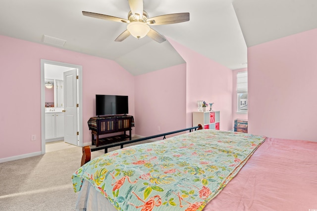 bedroom with ceiling fan, lofted ceiling, ensuite bath, and light carpet