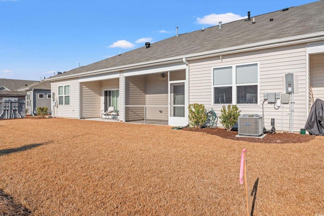 back of house with a lawn, central AC, and a patio area