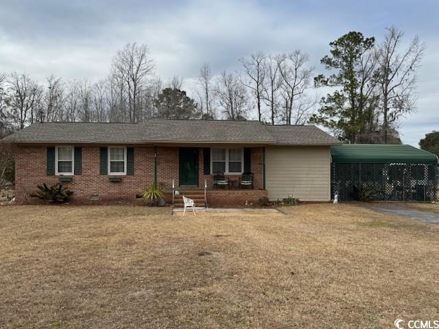 ranch-style house featuring a carport, covered porch, and a front lawn