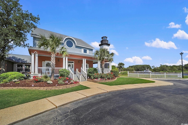 view of front of property with a porch and a front yard