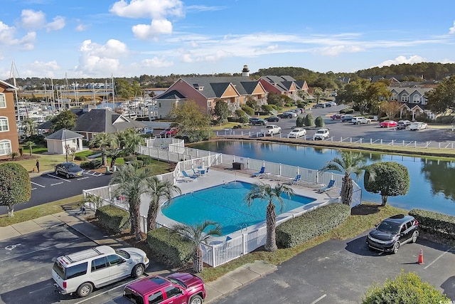 view of swimming pool featuring a patio area and a water view