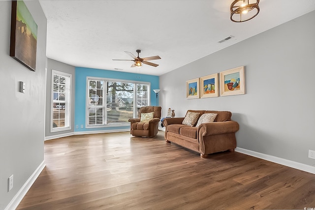 living room featuring hardwood / wood-style floors and ceiling fan