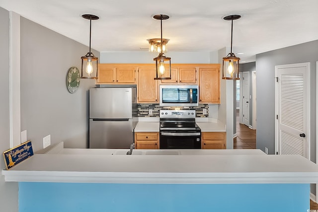 kitchen with pendant lighting, stainless steel appliances, and light brown cabinetry