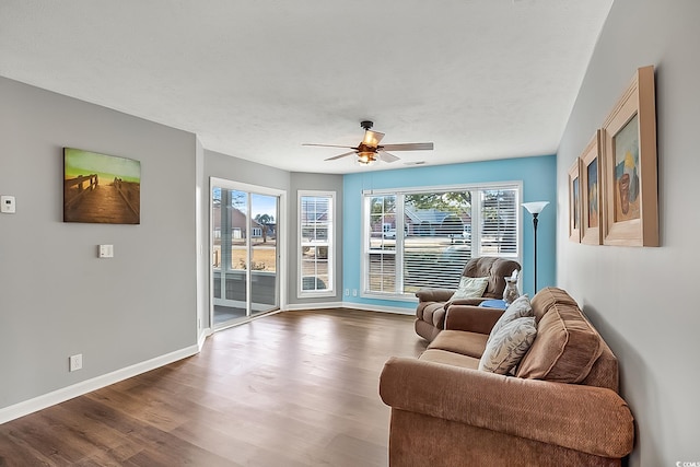 living area featuring ceiling fan and hardwood / wood-style floors