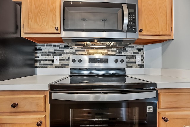 kitchen with stainless steel appliances and backsplash