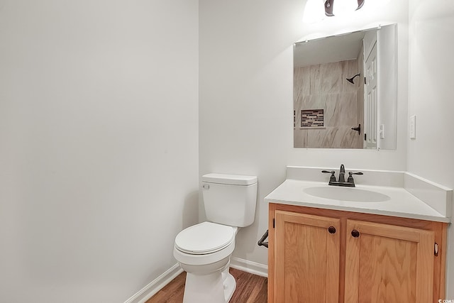 bathroom with vanity, toilet, and wood-type flooring