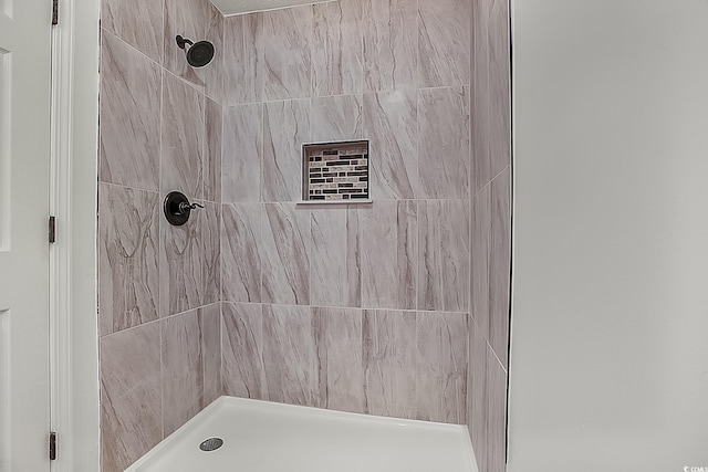 bathroom with tiled shower