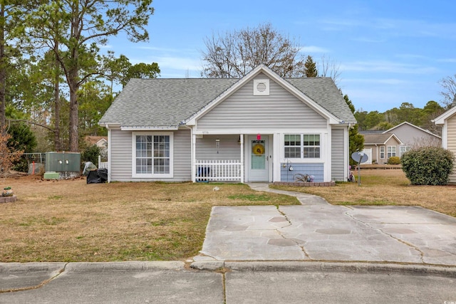 6716 Wisteria Dr, Myrtle Beach, SC 29588 - bungalow-style home featuring a porch, a shingled roof, and a front yard