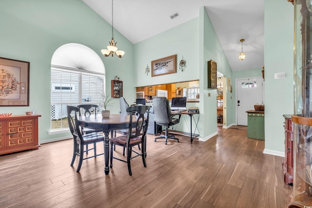 6716 Wisteria Dr, Myrtle Beach, SC 29588 - dining room with baseboards, wood finished floors, visible vents, and high vaulted ceiling