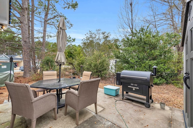 view of patio with area for grilling and outdoor dining space