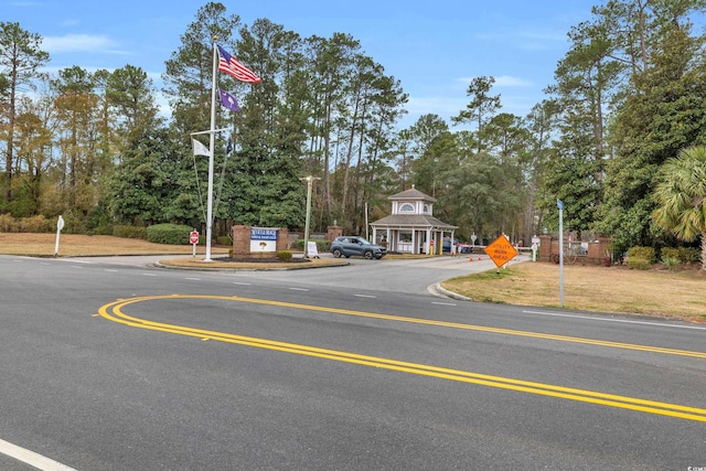 6716 Wisteria Dr, Myrtle Beach, SC 29588 - view of road featuring curbs and traffic signs