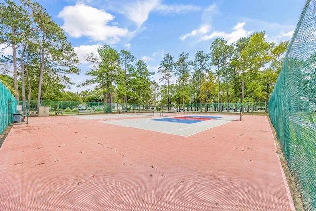 view of sport court featuring fence