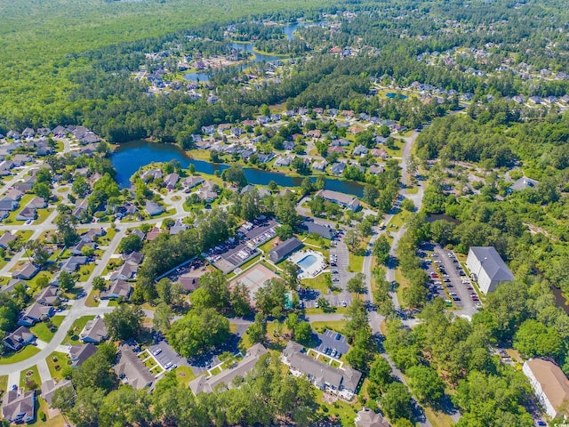 drone / aerial view with a water view, a forest view, and a residential view