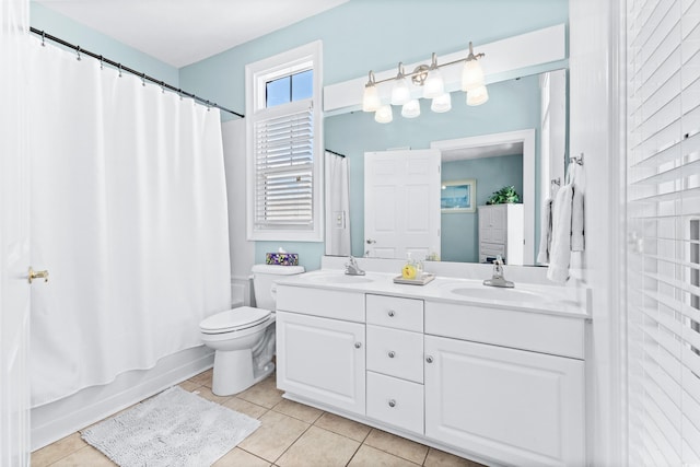 full bath with double vanity, toilet, shower / tub combo with curtain, tile patterned flooring, and a sink