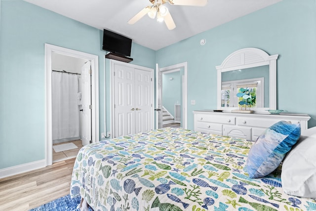 bedroom with light wood finished floors, ceiling fan, baseboards, and ensuite bathroom