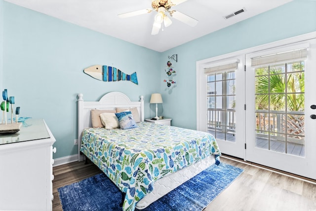 bedroom featuring visible vents, ceiling fan, wood finished floors, access to outside, and baseboards