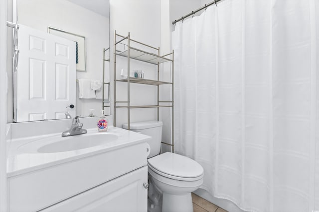 bathroom with a shower with shower curtain, vanity, toilet, and tile patterned floors