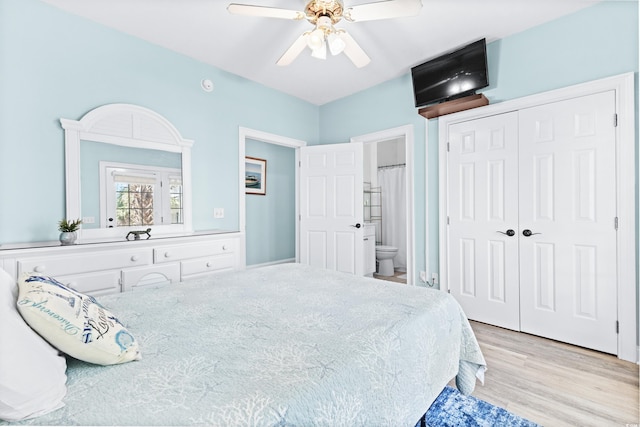 bedroom featuring light wood-type flooring, a closet, ceiling fan, and ensuite bath