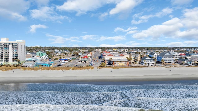 drone / aerial view with a water view and a beach view