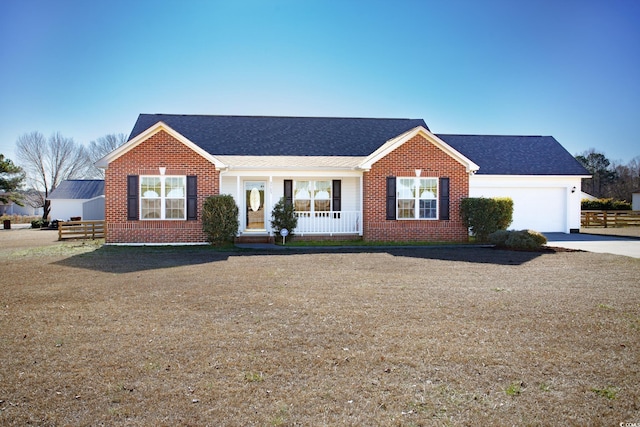 single story home featuring a porch and a garage