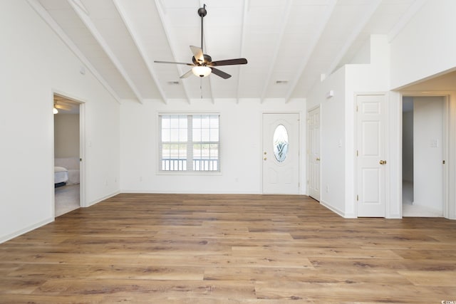 foyer with hardwood / wood-style flooring, ceiling fan, and vaulted ceiling with beams