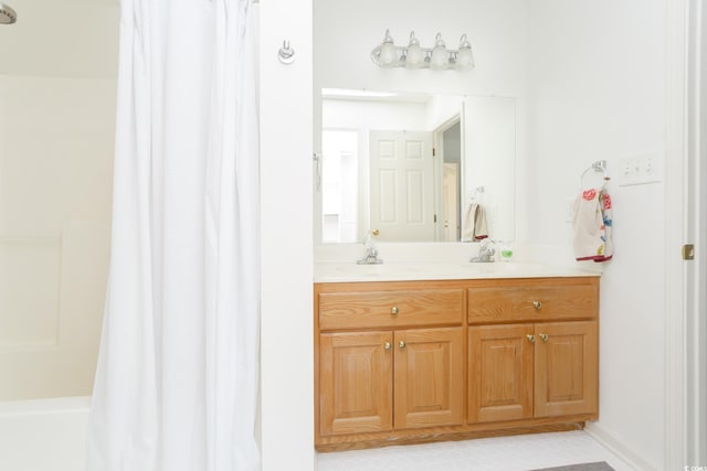 bathroom featuring vanity and shower / bath combination with curtain