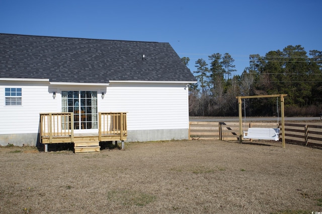 rear view of property featuring a deck