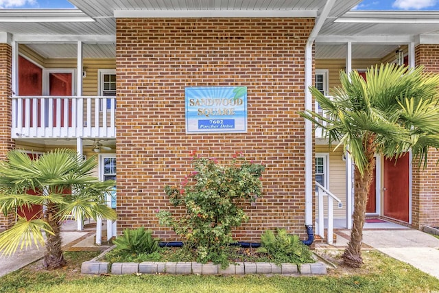 7602 Porcher Dr Unit C, Myrtle Beach, SC 29572 - view of property exterior with brick siding and a balcony