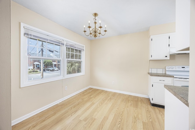 7602 Porcher Dr Unit C, Myrtle Beach, SC 29572 - unfurnished dining area featuring light wood finished floors, baseboards, and an inviting chandelier