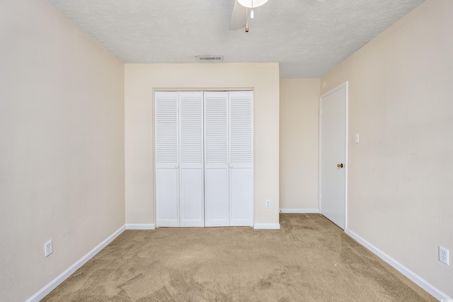 7602 Porcher Dr Unit C, Myrtle Beach, SC 29572 - unfurnished bedroom featuring carpet, baseboards, a textured ceiling, visible vents, and a closet