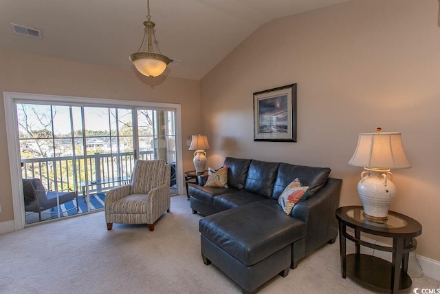 living room featuring light carpet and vaulted ceiling