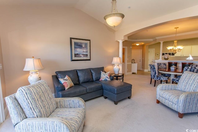 carpeted living room featuring ornamental molding, lofted ceiling, decorative columns, and a notable chandelier