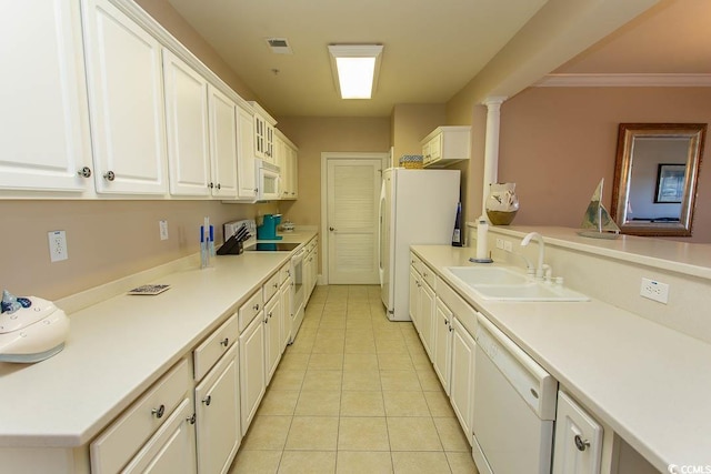 kitchen featuring sink, white cabinets, light tile patterned floors, crown molding, and white appliances