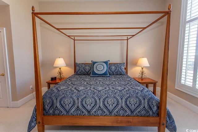 bedroom with carpet floors and multiple windows