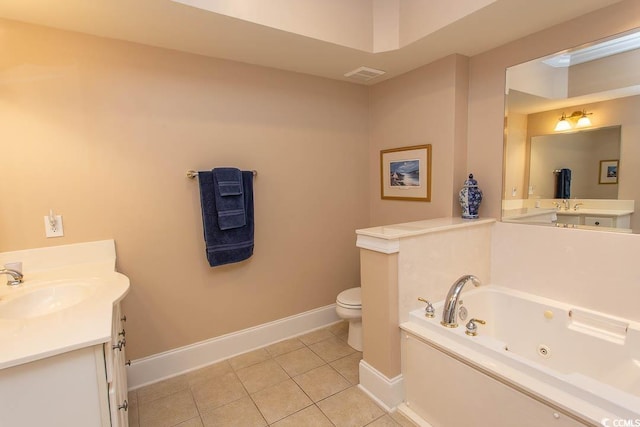 bathroom featuring tile patterned flooring, vanity, toilet, and a tub to relax in