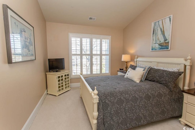 carpeted bedroom featuring vaulted ceiling