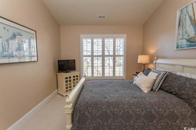 carpeted bedroom with lofted ceiling