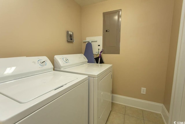 laundry room featuring light tile patterned flooring, electric panel, and washing machine and dryer