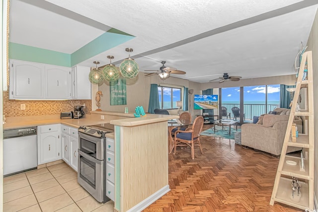 kitchen featuring white cabinetry, appliances with stainless steel finishes, kitchen peninsula, and backsplash